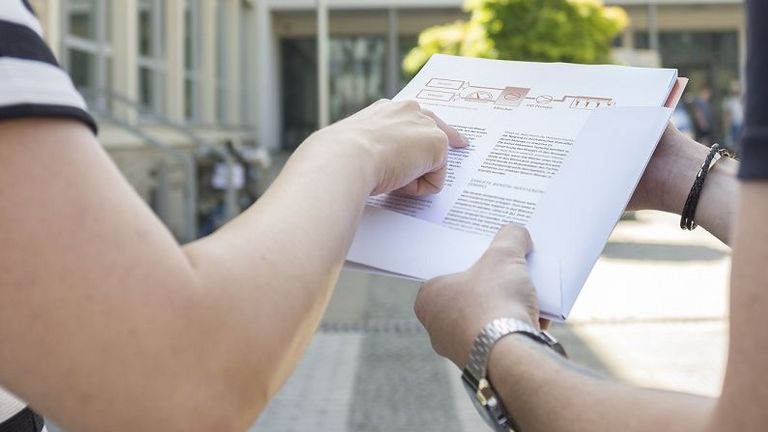 two persons looking for a paper